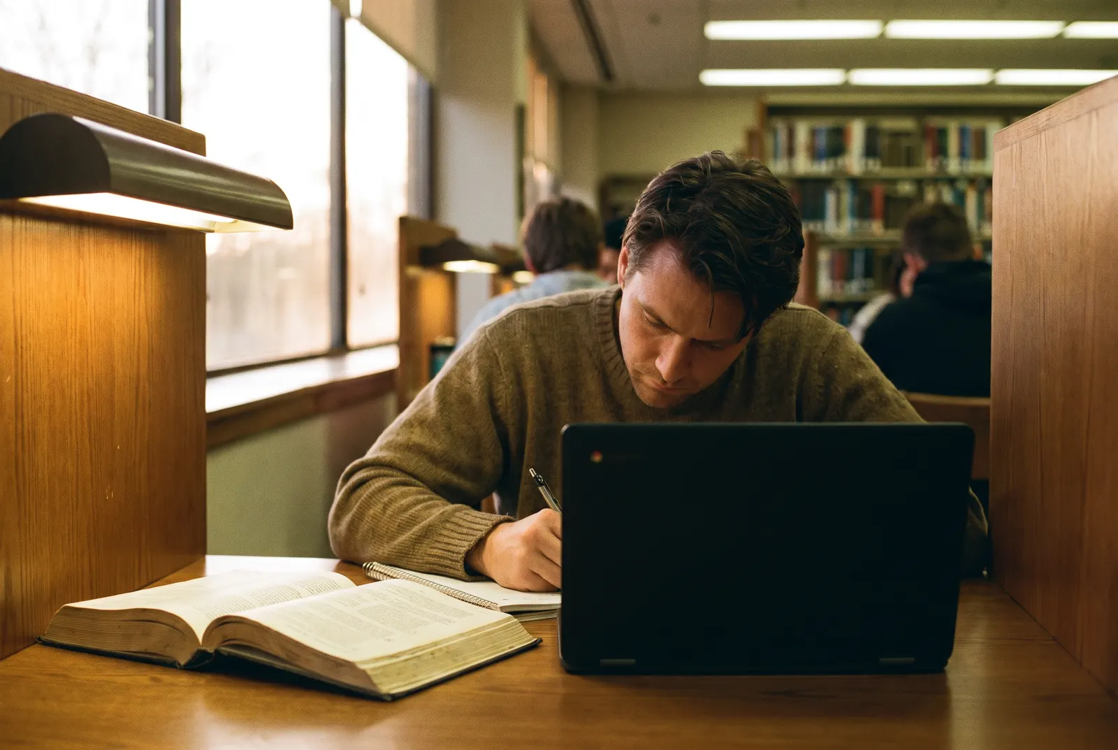 Adult learner at a library study carrel with a textbook and notebook, completing an accounting certificate
